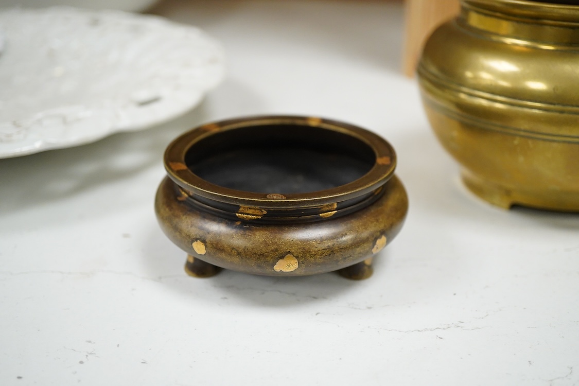 A Chinese bronze censer with gilt splashed decoration, signed with character marks to the base, together with another gilt censer, largest 12cm in diameter